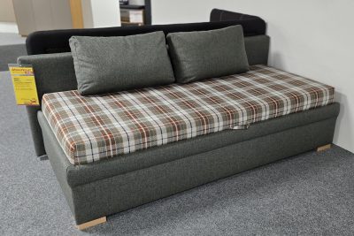 Einzelliege Stoff olivgrün, lose Federkernmatratze kariert. Mit Gasdruckdämpfer, Bettkasten, Lattenrost mit Kopfteilverstellung, Kissen und Rückwand. Liegehöhe 50 cm, Liegefläche 90 x 200 cm. Außenmaß: B 220 x H 78 x T 104 cm